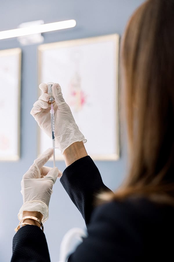 Dr. Tulsi Kotecha reviewing a peptide therapy protocol with a patient at Refine by Tulsi in Chicago